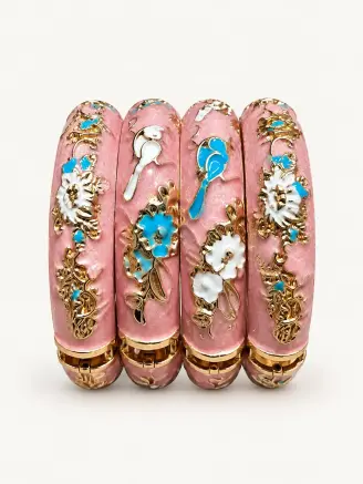 Baby pink enamel metal bangles featuring white and turquoise floral motifs with decorative golden detailing.