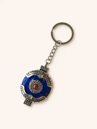 Blue round decorative keychain with ornate silver design and metal keyring