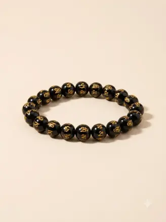 Om Mani Padme Hum stretchable black bead bracelet with golden mantra detailing angled view